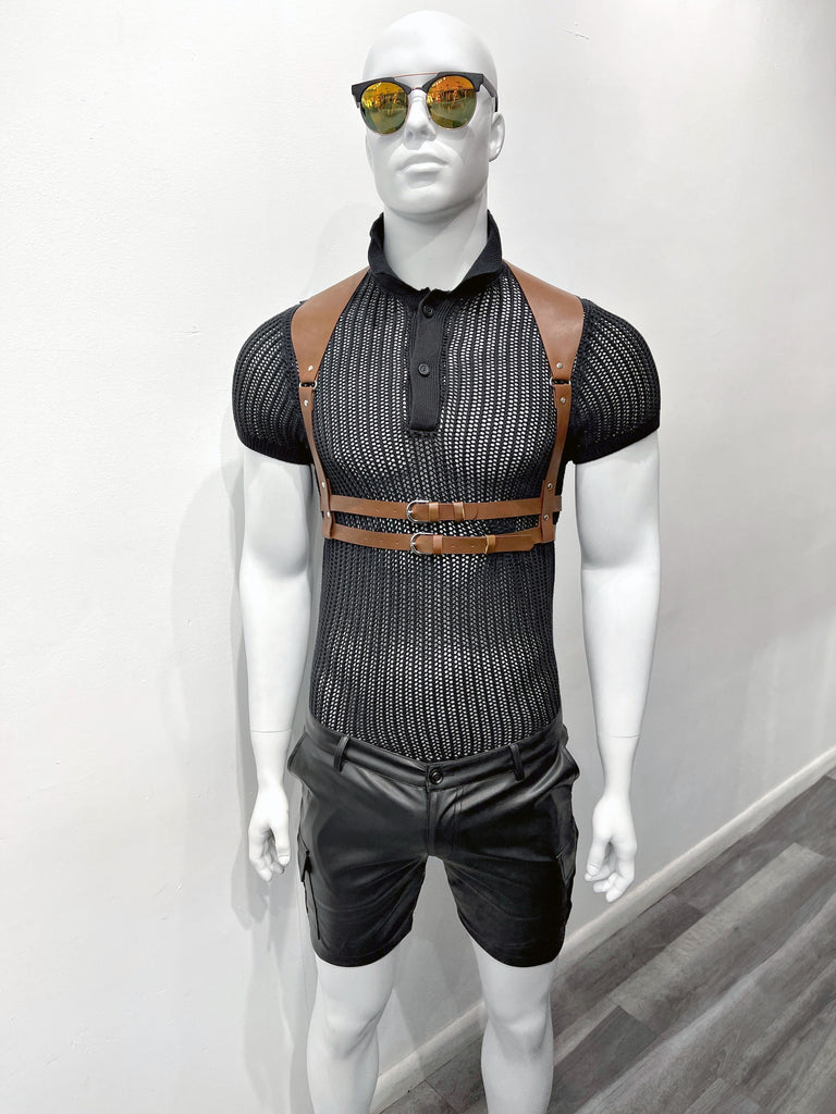 A mannequin orange mirrored sunglasses, a black open knit polo, a brown waist harness, and leather utility shorts.