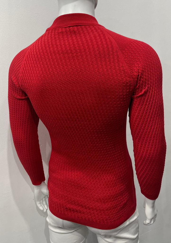 Brick long-sleeve, turtleneck sweater with raglan sleeve design as seen from the back. There is a waffle weave pattern woven into the knit fabric.