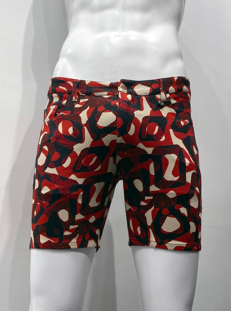 Zip-front, 5-pocket stretch knit shorts with beige, poppy red, and black mod pattern of overlaying rings of different shapes and thicknesses, as seen from the front.