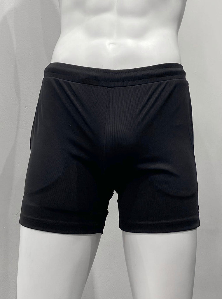 Black athletic shorts with lightly ribbed fabric as seen from the front, with elastic waistband and two front pockets.