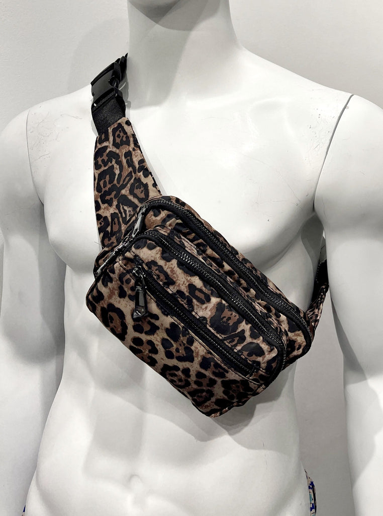  Leopard print fanny pack with a gold exterior zipper, black vegan leather detailing, and an adjustable waist band with easy release latch.