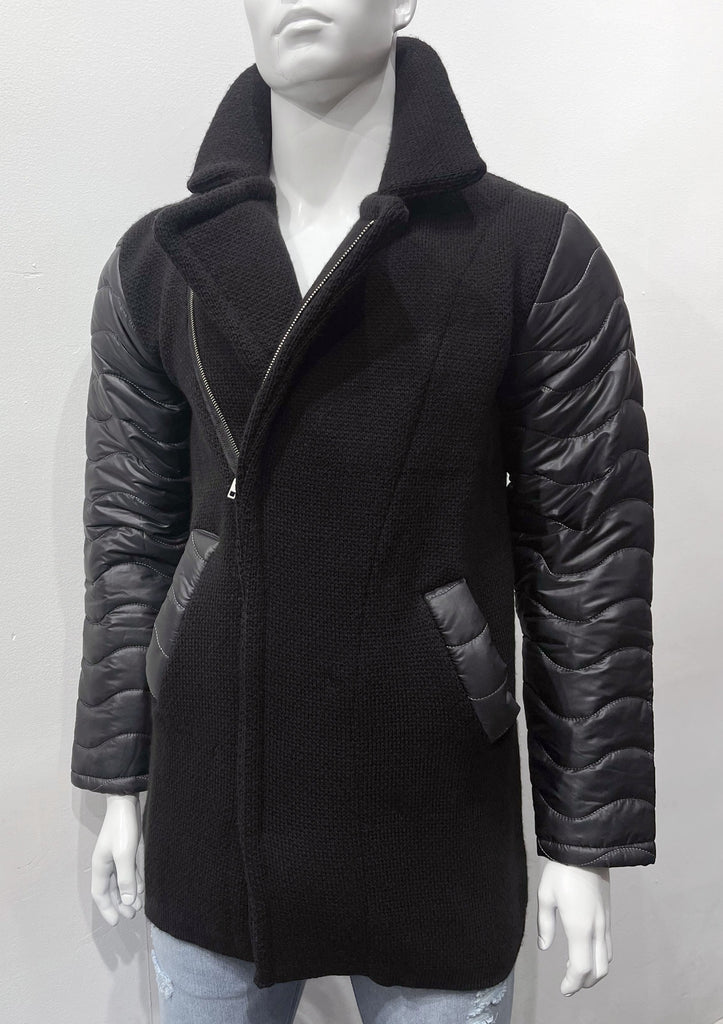 Black, double-breasted overcoat with silver zipper closure instead of buttons, as seen from the front. Sleeves and pockets are lined with puffer coat material.