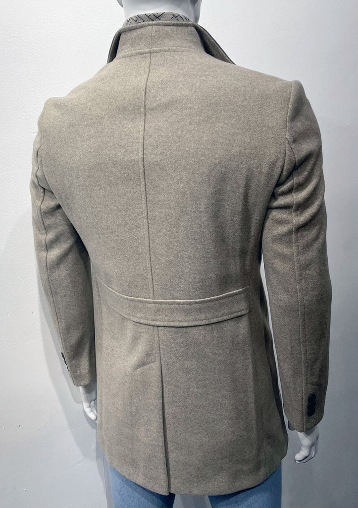 Beige overcoat as seen from the back.