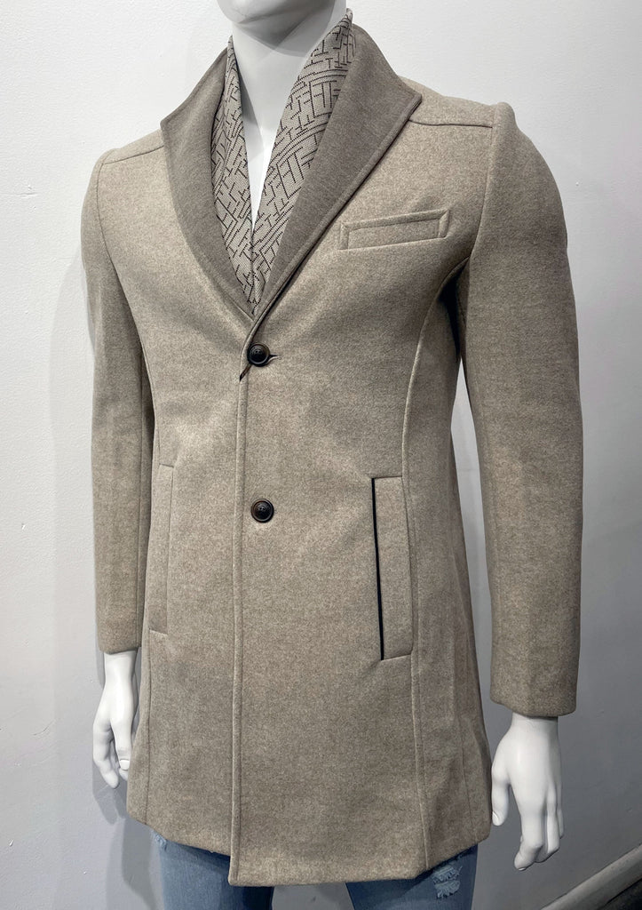 Beige overcoat as seen from the front, with two dark brown buttons on the front, a slightly darker beige collar, and a light beige neck scarf feature on the inside of the collar with a dark brown geometric pattern on it.