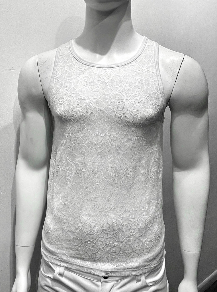White tank top made from mesh material as seen from the front, with a floral pattern woven into the mesh.