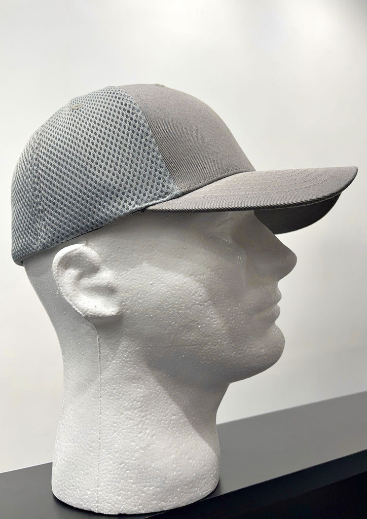   Grey fitted baseball cap, from the side. The brim and the front panel of the crown are brownish grey, and back of the crown is made of a light grey perforated material