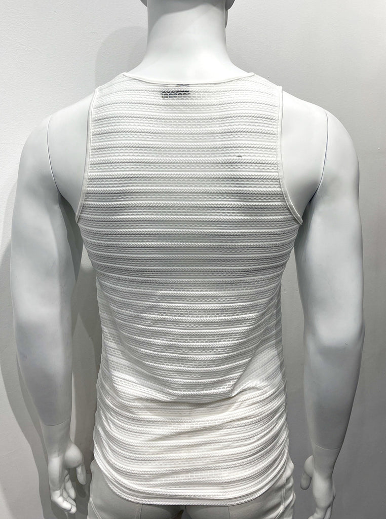 White tank top made from mesh material as seen from the back, with a horizontal eyelet stitch cable pattern woven into the mesh.