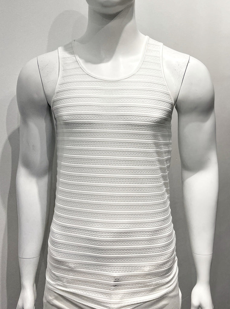 White tank top made from mesh material as seen from the front, with a horizontal eyelet stitch cable pattern woven into the mesh.