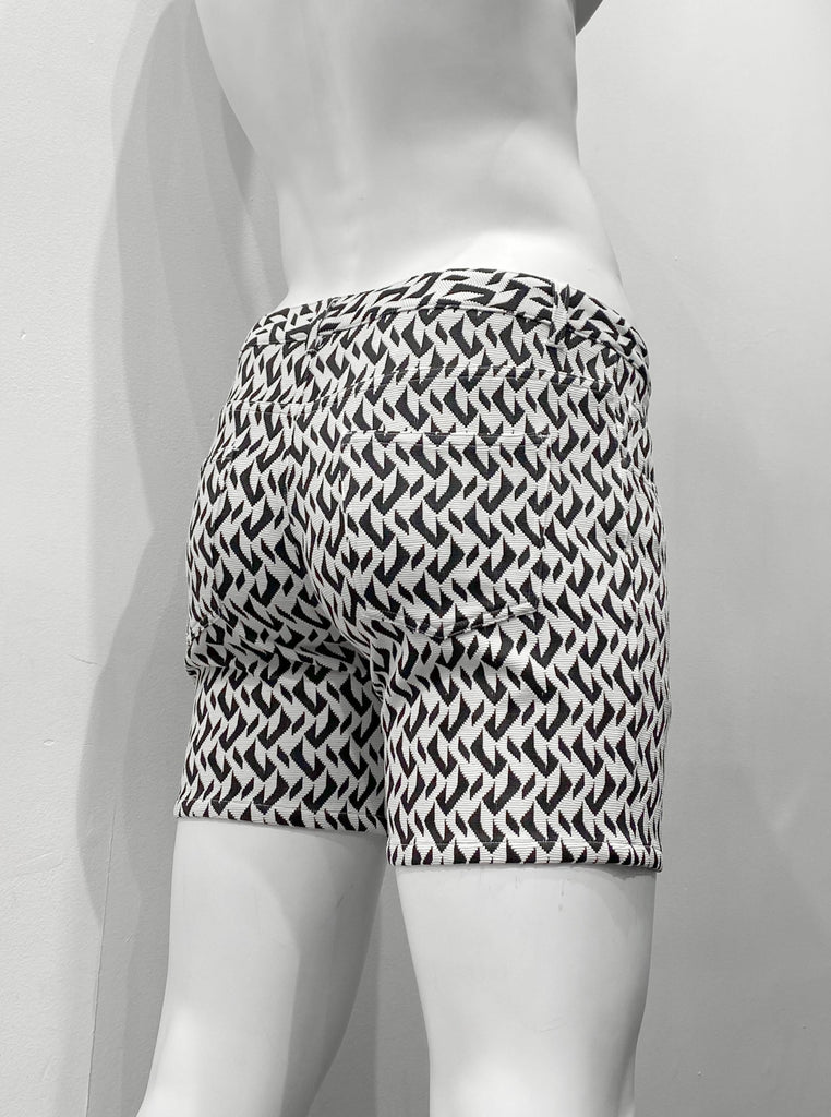 Zip-front, 5-pocket stretch knit shorts with a black and white herringbone pattern, as seen from the back.