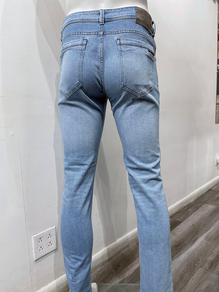Light blue distressed skinny denim jeans, as seen from the back.