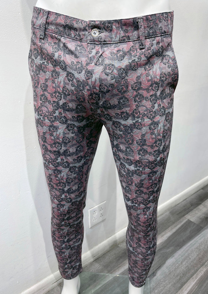 Flat front pants with a light blue, pink and grey layered ornate pattern, as seen from the front.