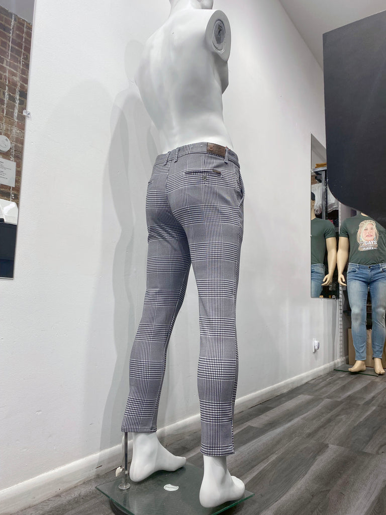 Grey slim fit pants with black plaid pattern, as seen from the back.