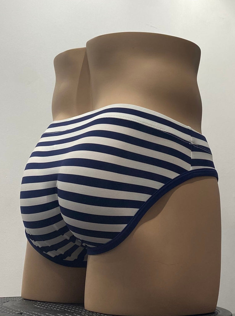 White swim brief as seen from the front, with horizontal blue stripes. Also there is blue piping around both leg openings.