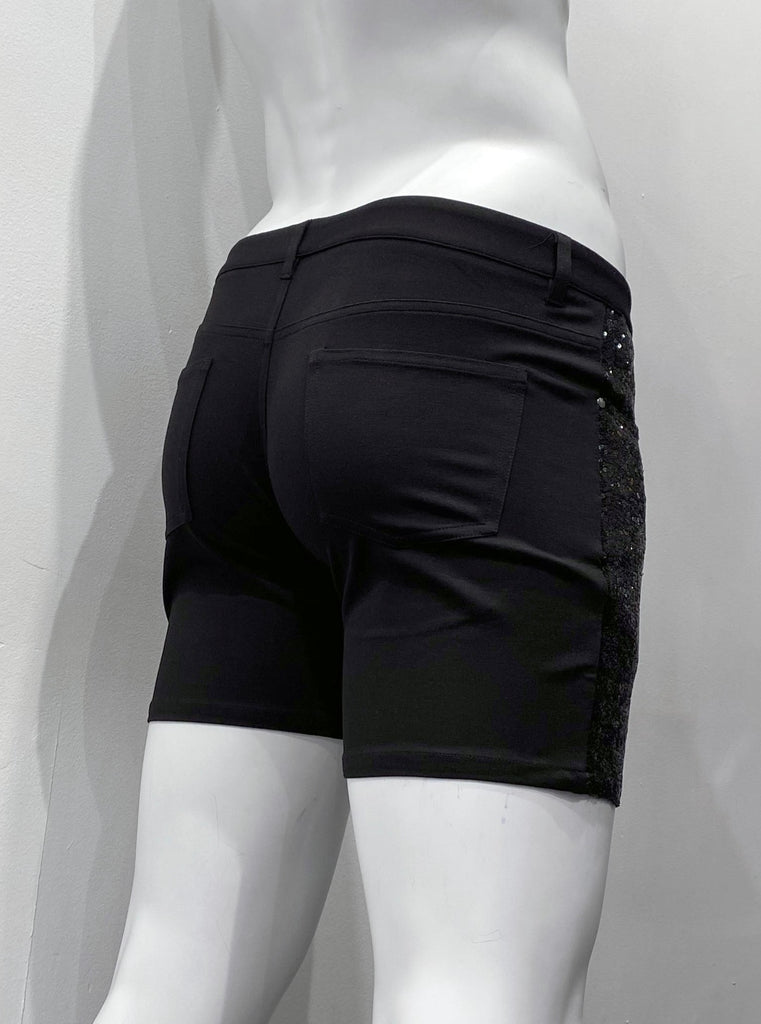 Black 5-pocket, zip-front, stretch knit shorts, as seen from the back. There are two back pockets and o sequins on the back.
