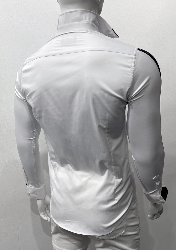 White button-down, long-sleeved shirt as seen from the back. The right shirt sleeve shoulder and  shirt sleeve cuff has black, sparkly detailing on them. 