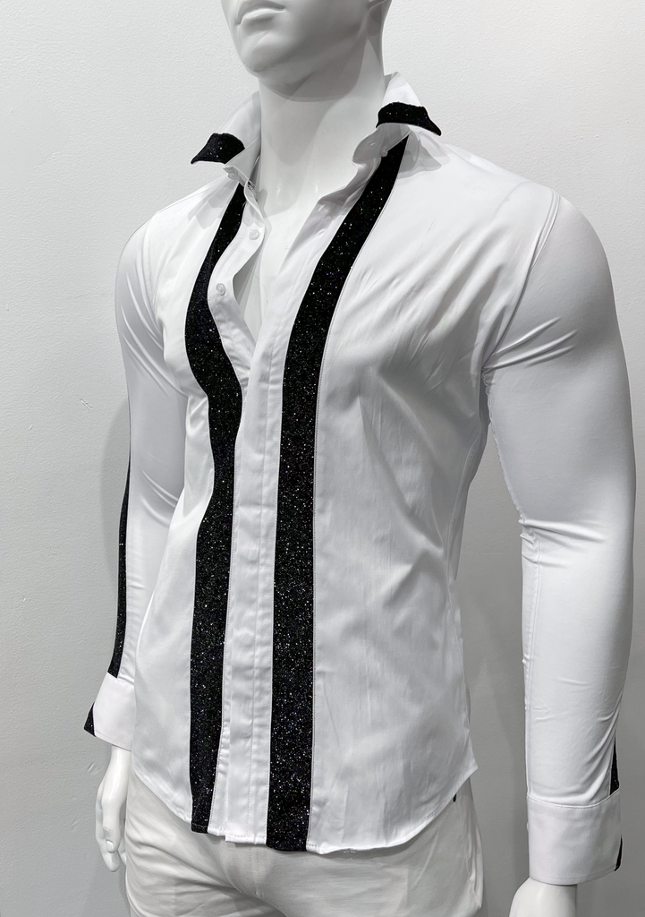 White button-down, long-sleeved shirt as seen from the front. Two vertical black sparkly stripes, one on either side of the button placket, extend down the front of the shirt. The front edge of the left and right collars, the right shirt sleeve, and both shirt sleeve cuffs have black, sparkly detailing on them, too.  