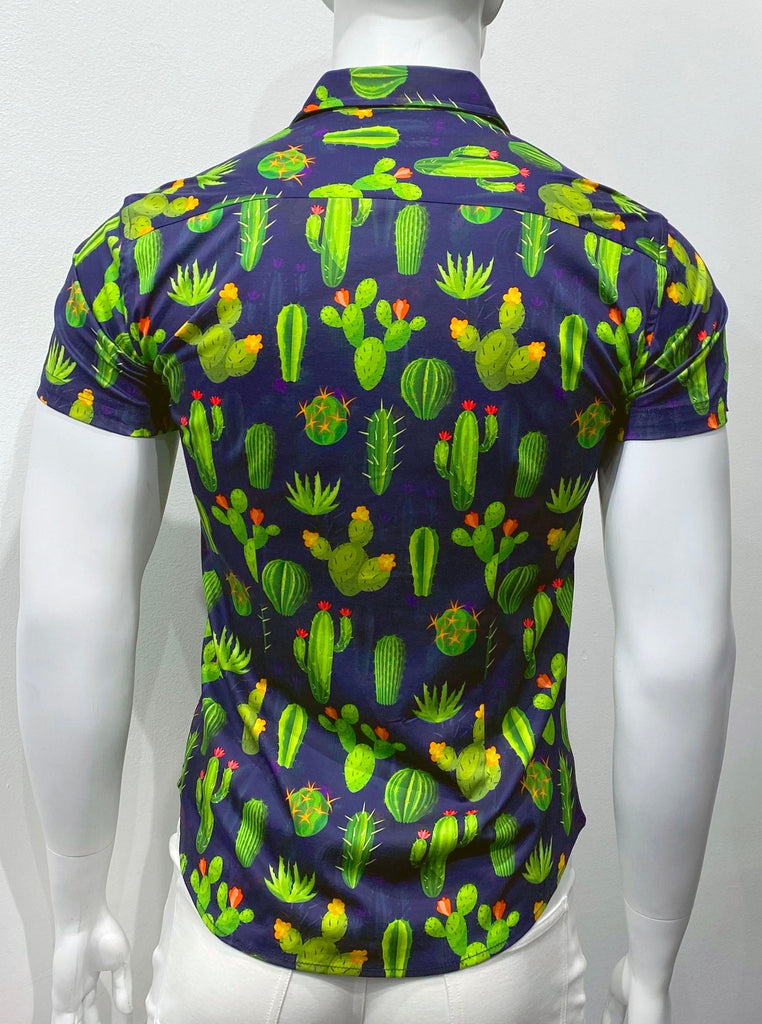 Short-sleeved, button-down collared shirt, as seen from the back, with a pattern comprised of bright green cactuses with bright yellow, red, and orange flower blossoms on them.