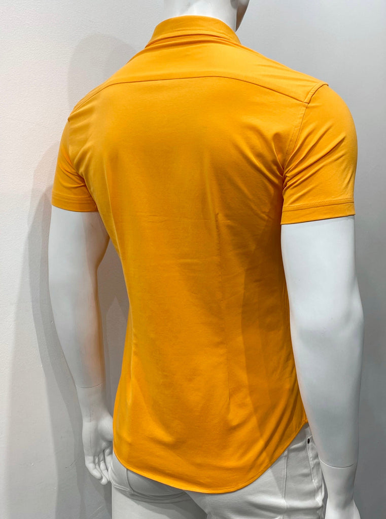 Papaya colored short sleeve button-down shirt as seen from the back. The buttons are papaya color.