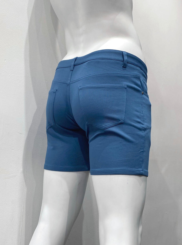 Lagoon blue, zip-front, 5-pocket stretch knit shorts, as seen from the back.