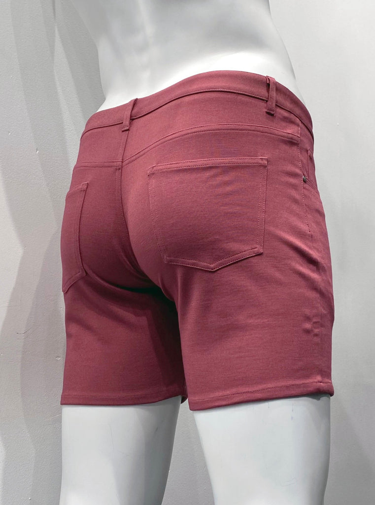 Brick red, zip-front, 5-pocket stretch knit shorts, as seen from the back.