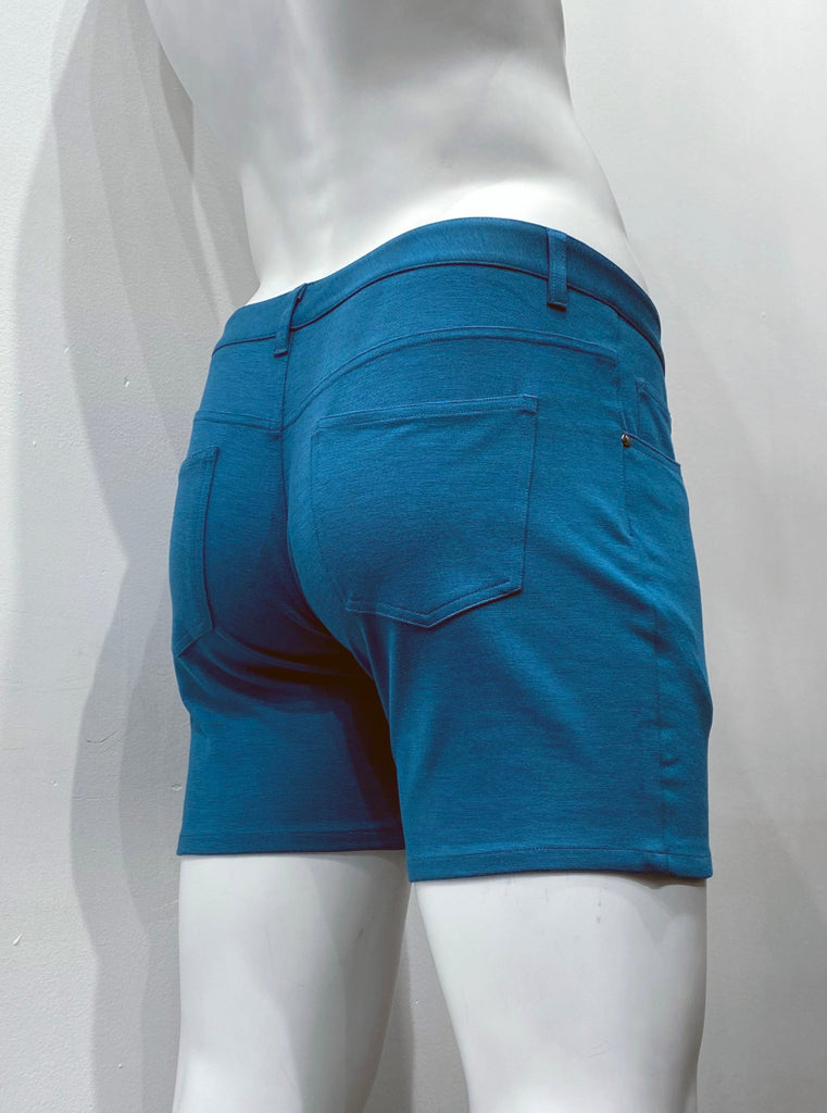 Calypso blue, zip-front, 5-pocket stretch knit shorts, as seen from the back.