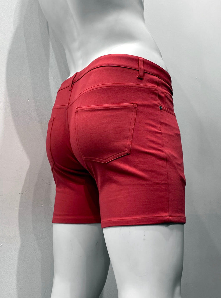 Poppy red, zip-front, 5-pocket stretch knit shorts, as seen from the back.