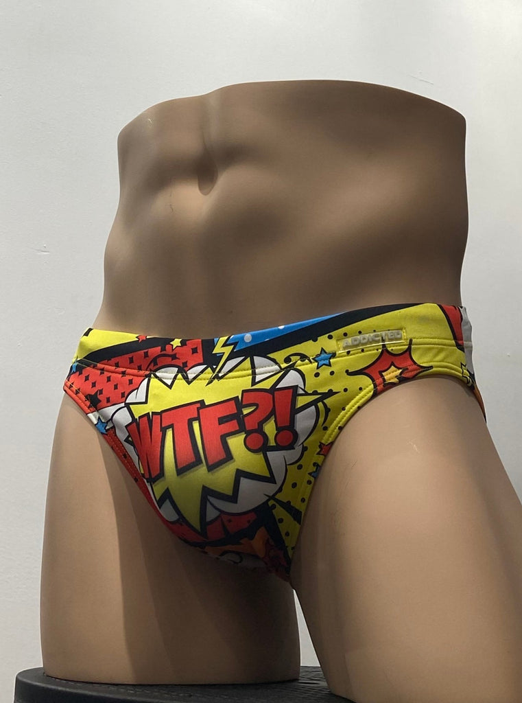 Multi-color swim brief with a yellow, blue, orange, red, and black pop art design as seen from the front. The letters WTF are written in red on the front pouch.