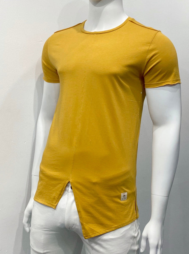 Golden yellow T-shirt with an extended torso length and an asymmetrical split hemline in the front, as seen from the front. The hem is split on the sides and about an inch higher in front than in the back.