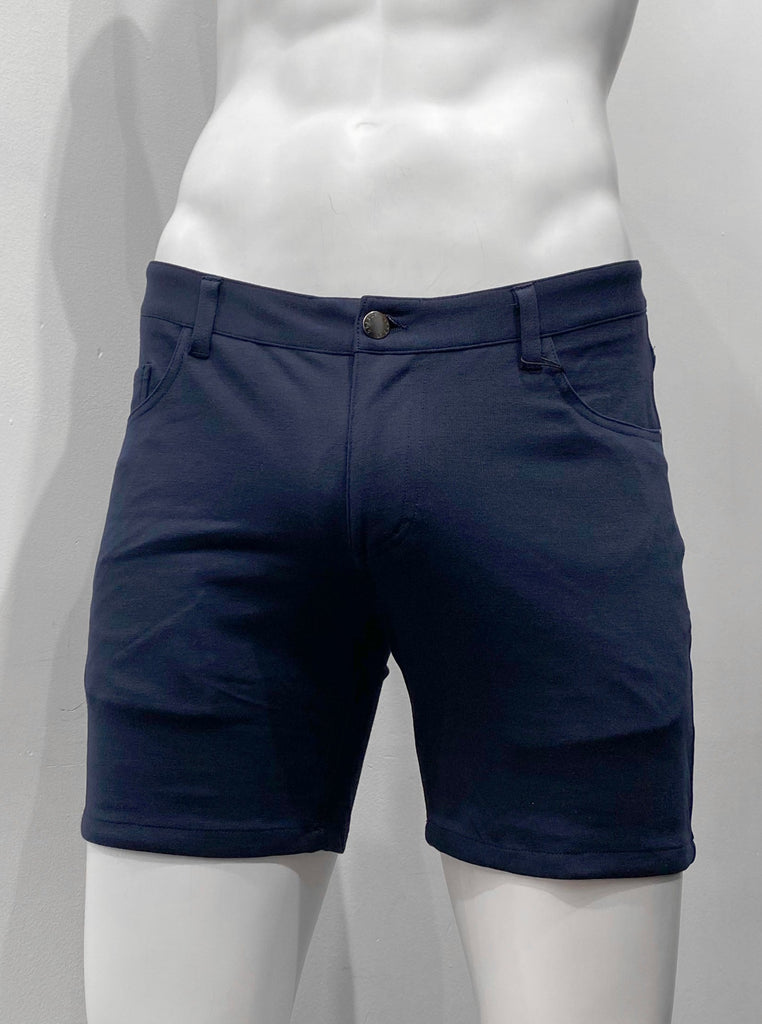 Navy blue, zip-front, 5-pocket stretch knit shorts, as seen from the front.