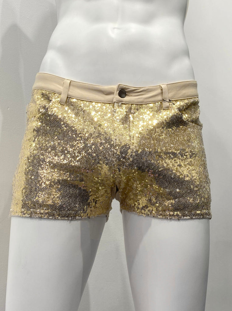 Stretch knit short-shorts with gold sequins covering them, as seen from the front. They are zipper-front with two front pockets. There are no sequins on the waistline belt loops, exposing light beige fabric.