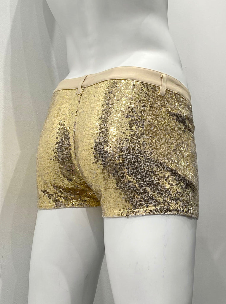 Stretch Knit short-shorts with gold sequins covering them, as seen from the back. There are no back pockets.  There are no sequins on the waistline belt loops, exposing beige knit fabric