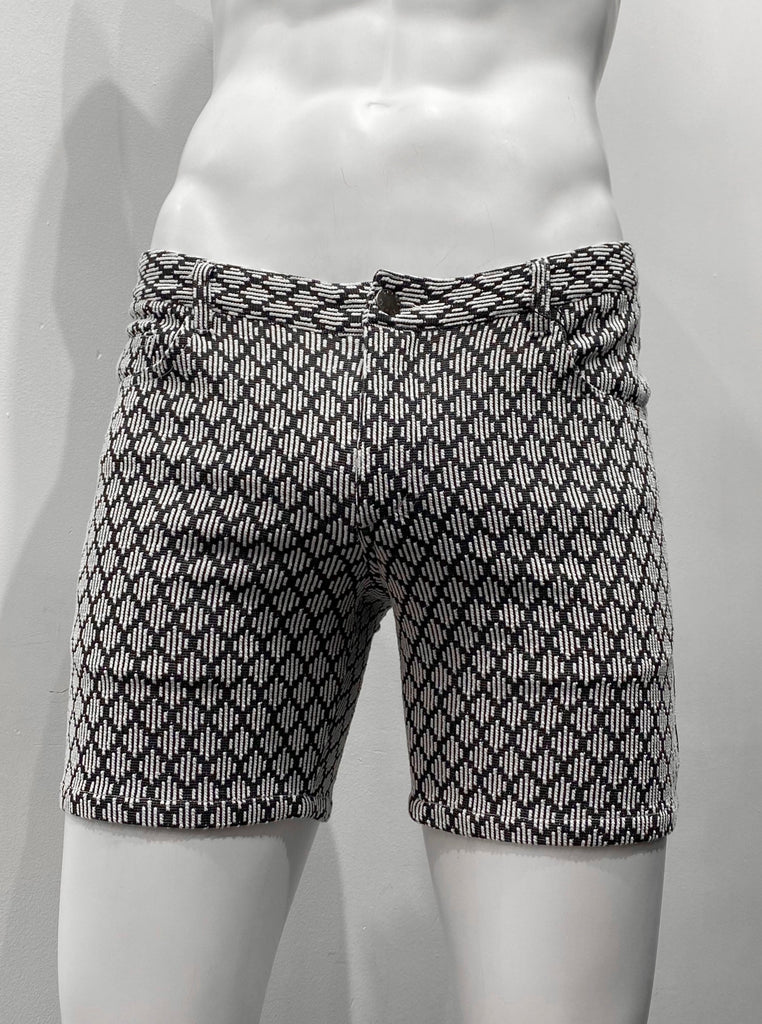 Zip-front, 5-pocket black stretch knit shorts as seen from the front, with a textured diamond pattern made up of little, equally-sized diamond shapes woven into the black fabric. Each diamond shape is made of little white horizontal lines.