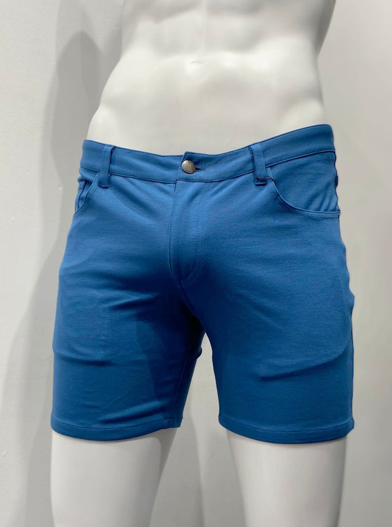 Marine blue, zip-front, 5-pocket stretch knit shorts, as seen from the back.