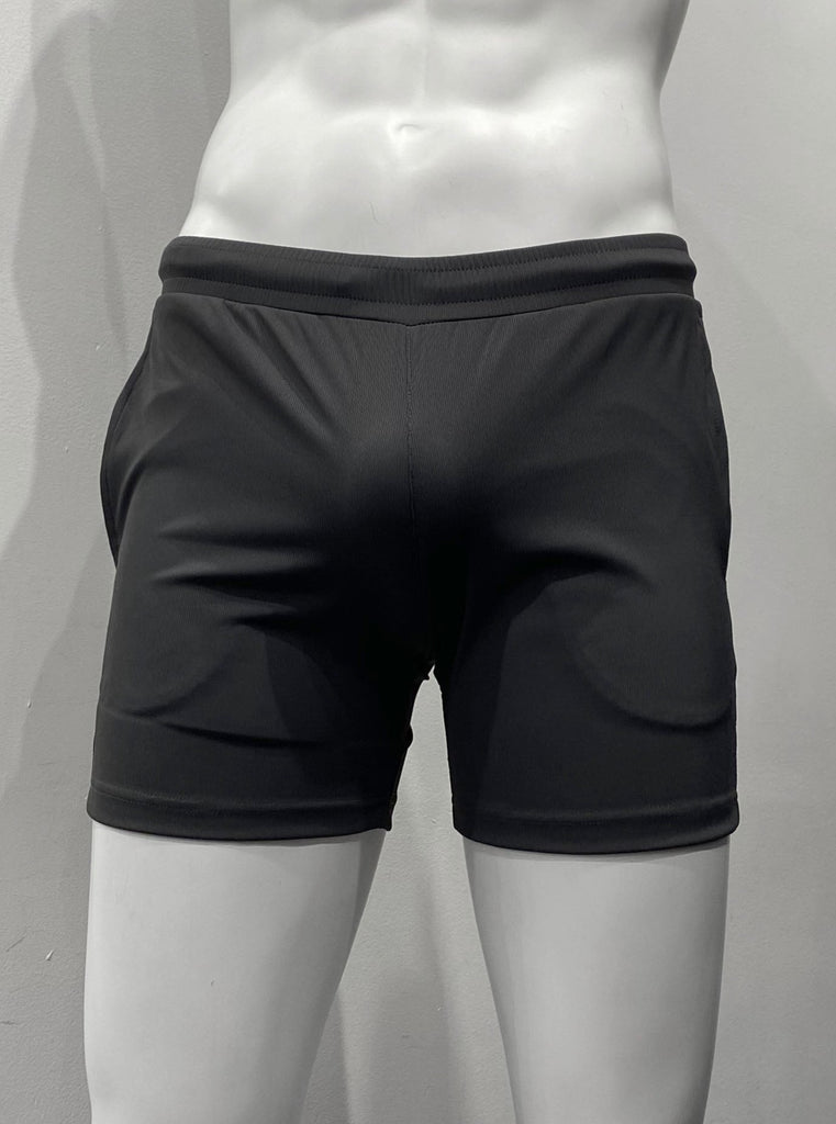 Charcoal grey athletic shorts with lightly ribbed fabric as seen from the front, with elastic waistband and two front pockets.