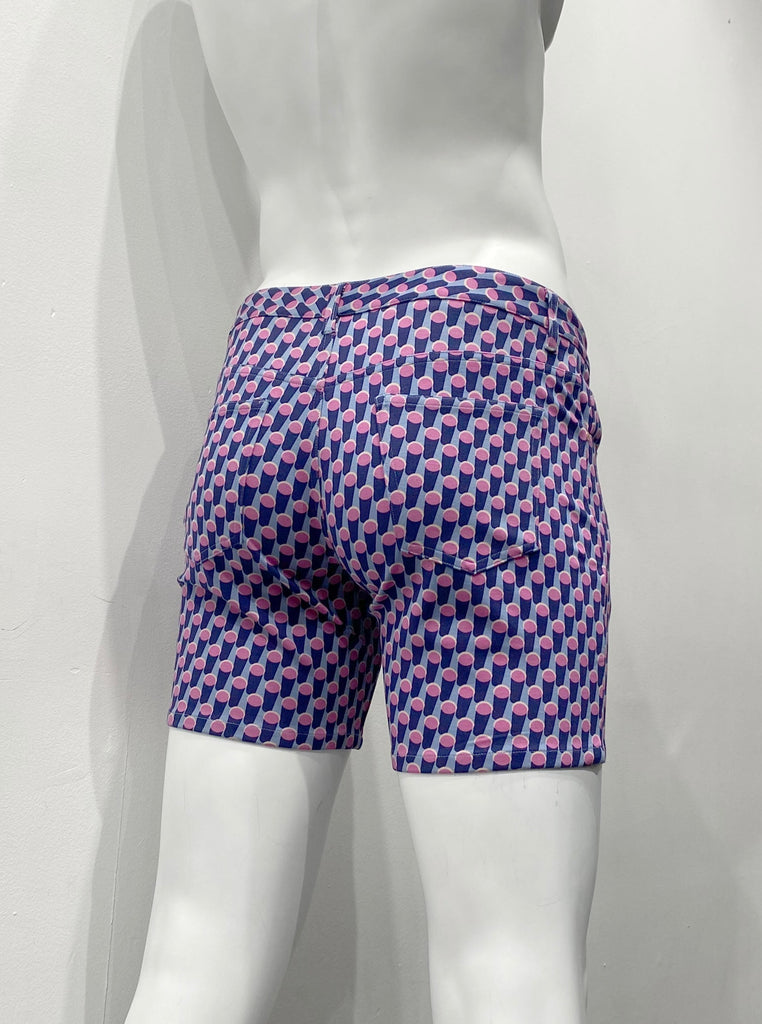 Zip-front, 5-pocket lavender stretch knit shorts as seen from the back, with a pattern of a crowd of standing blue cylinders with pink ends.