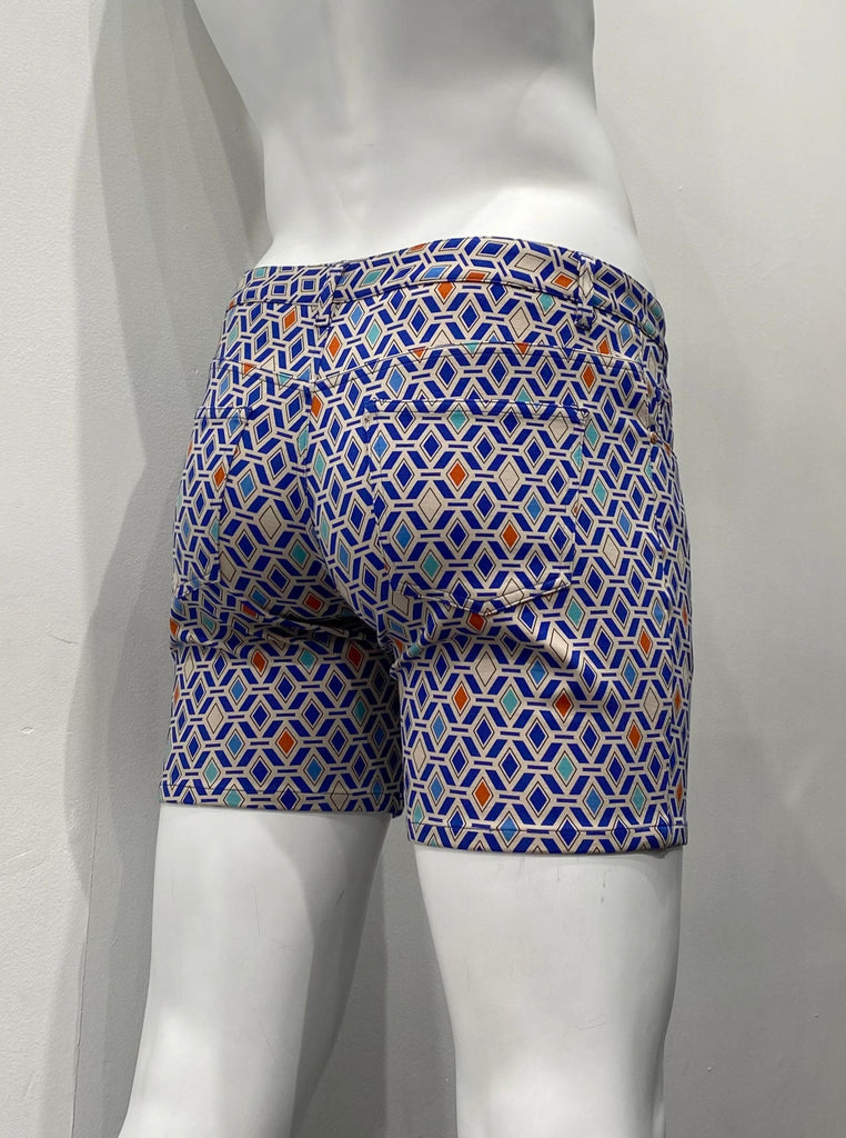 Zip-front, five-pocket stretch knit shorts as seen from the back, with a geometric pattern of grey, dark blue, royal blue, turquoise, and orange diamonds on grey background.