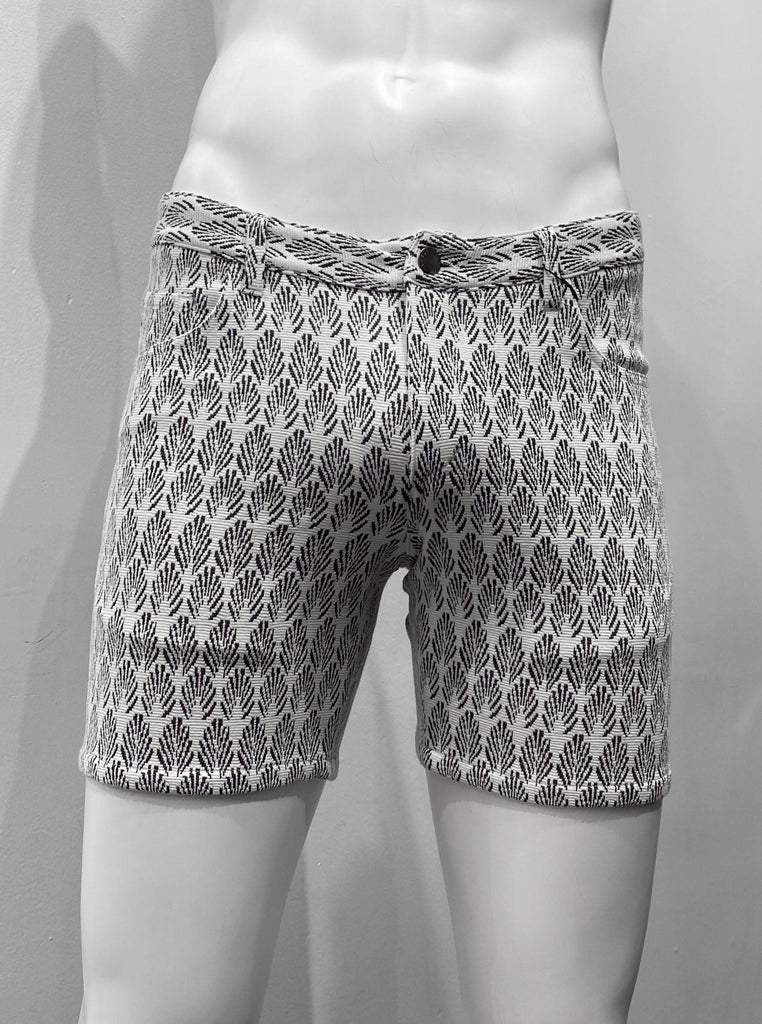 Zip-front, 5-pocket white stretch knit shorts as seen from the front, with black art deco palms pattern covering the fabric.