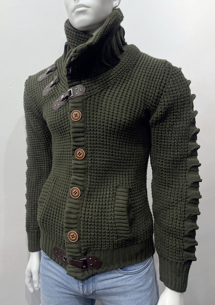 Olive high-collared cardigan sweater as seen from the front, with large brown buttons, a brown leather latch and strap fastener in place of the top button, two brown leather straps and latch details on the right breast, and a brown latch and strap detail center-front along the hem.