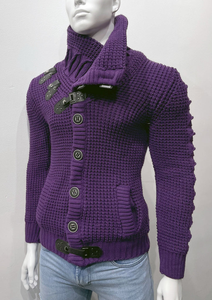 Purple high-collared cardigan sweater as seen from the front, with large grey buttons, a grey leather latch and strap fastener in place of the top button, two grey leather straps and latch details on the right breast, and a grey latch and strap detail center-front along the hem.