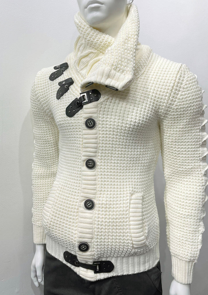 Ecru high-collared cardigan sweater as seen from the front, with large grey buttons, a grey leather latch and strap fastener in place of the top button, two grey leather strap and latch details on the right breast, and one grey latch and strap detail center-front along the hem.