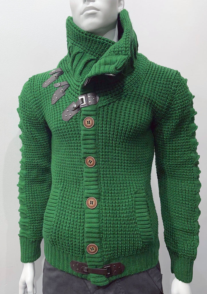 Green high-collared cardigan sweater as seen from the front, with large brown buttons, a brown leather latch and strap fastener in place of the top button, two brown leather strap and latch details on the right breast, and one brown latch and strap detail center-front along the hem.