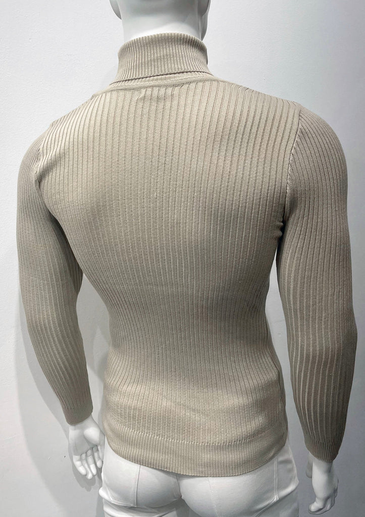 Tan long-sleeve, turtleneck sweater as seen from the back. There is a vertical ribbed pattern woven into the knit fabric.
