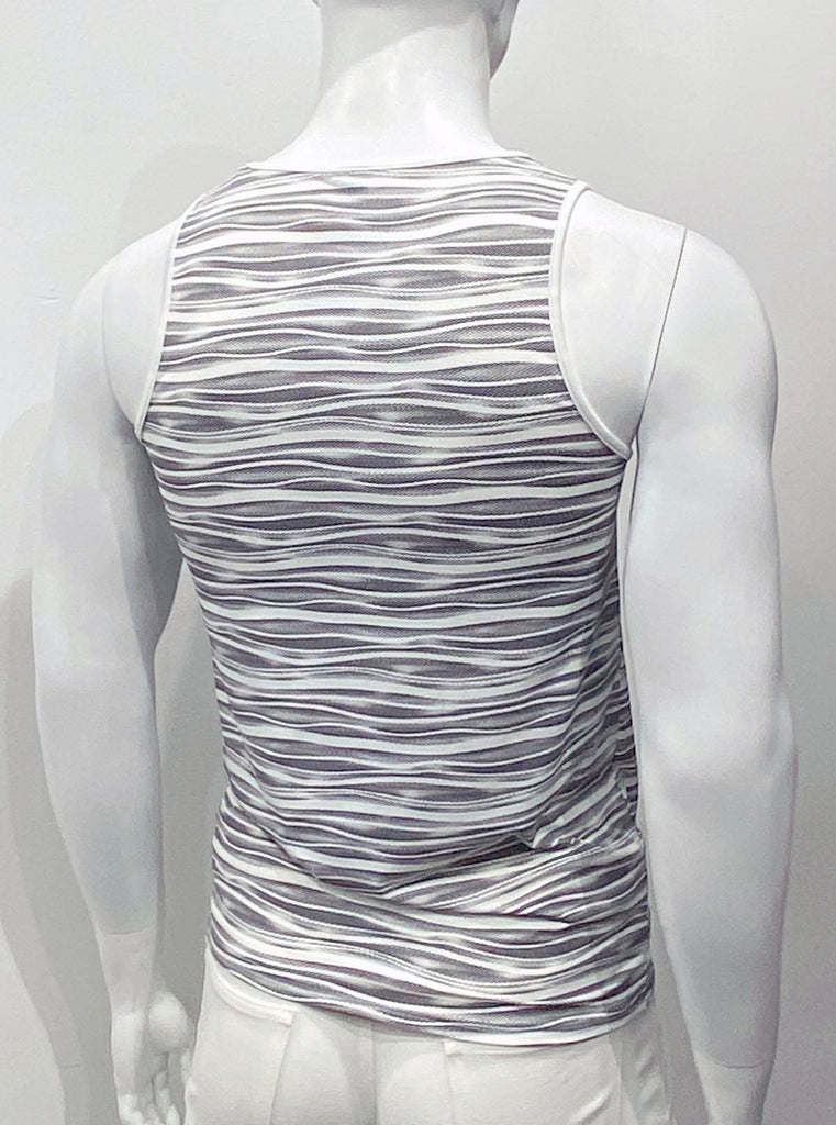 Perforated white mesh tank to as seen from the back, with a pattern of black wavy horizontal lies covering the back. There is white piping on the shoulder straps and around the neck.